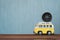 Image of a toy miniature yellow minivan with a compass