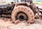 The image of tractor wheel in the mud