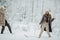 Image of two blondes throwing snow on walk in winter forest