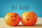 Image of two clementines with drawn smiley faces