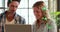 Image of two globes of digital icons against caucasian man and woman over a laptop at office