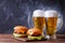 Image of two hamburgers, glasses with beer