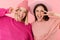 Image of two positive girls smiling and showing peace sign