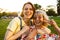 Image of two women gesturing peace sign and hugging while walking