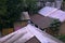 A image of a typical village hut with a pigeon sitting on the rooftop