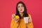 Image of unhappy girl holding lemon and ginger while drinking tea