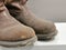 Image of used high cut safety shoes by Red Wing isolated on grey background.