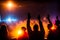 image of the a vast crowd of hands, illuminated by a dreamy and foggy light towards the front auditorium.