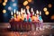 Image Vibrant birthday cake with burning candles against blurred lights background