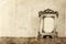 Image of victorian vintage antique classical frame on wooden table. filtered image