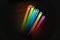 Image of vint neon glow sticks forming rainbow, abstract, colors