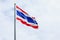 Image of waving Thai flag of Thailand with sky background.