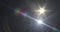 Image of white light with beam and prismatic lens flare on dark background
