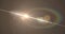 Image of white light with beam and prismatic lens flare on grey background