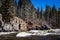 Image of white water rapids in a pristine river in the boreal forest on a sunny day.