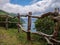 Image of wodden fence in front of a cliff with coast and sea in the background