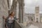 Image of a woman in the belfry of the city of Ghent Belgium and the facade of the Cathedral of St Bavon in the background