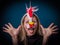Image of a woman in chick costume with hands up. Having fun.