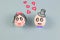 Image of a woman and man in the shape of an egg on a blue background. The expression of emotions of love, embarrassment,