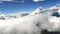 Image of a woman parachutist in casual clothes doing a dive among the clouds, in slow motion with 4K resolution.