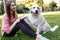 Image of woman on walk with labrador giving paw