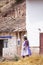 Image of a woman walking in Andean Villa in Peru.