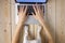 Image of womanâ€™s hands typing fast on laptop keyboard with dogâ€™s paws on same tabletop. View from above. Remote work from home