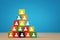 image of a wood blocks pyramid with people icons over wooden table, human resources and management concept.