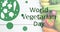 Image of world vegetarian day text in green with logo, over fresh vegetables on white boards