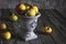 Image of wrinkled apples in an old vase on a shabby wooden table
