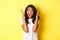 Image of young african american woman looking annoyed, screaming bothered and angry, standing over yellow background