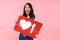 Image of young brunette asian woman holding heart like symbol on placard