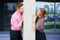 Image of a young couple hugging a concrete pole