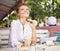 Image of young red hair and pretty woman with cup of coffee laughing in cafe