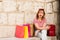 Image of a young woman shopping during the sales with her mobile phone. colorful picture. summer`s afternoon