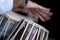 Images of a man`s hands wearing beads playing the Tabla. -