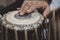Images of a man`s hands wearing beads playing the Tabla. -