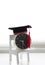 Images of mortarboard on a toy chair and an alarm clock, isolate