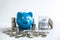 Images of stacking coins pile and blue smiling piggy bank to growing and savings with money box, Saving money for future plan and