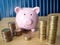 Images of stacking coins pile with pink piggy bank, for planning to grow and save money, Saving money for future and retirement