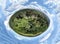 Imaginative spherical, abstract panoramic aerial view in a field with fantastic beautiful clouds and the curvature of space like a
