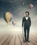 Imaginative vintage businessman with hot air ballons