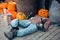 Imitation of a drunk homeless man lying on the road at a cafe with bottles of alcoholic beverages, in the style of Halloween,
