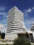 Immaculate white apartment building rising into a blue sky