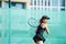 Immersed 16yo girl playing tennis on a new court, ready to return ball