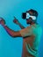 Immersed in a digital realm, an African American man navigates the virtual landscape with a VR goggles, using tactile