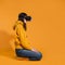 Immersion in cyberspace, virtual reality and the user. A gamer in a yellow hoodie