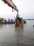 Immersion of ma kali  idol by crane in the holy river ganges at kolkata.