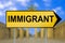 Immigrant traffic sign with blurred Berlin background