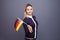 Immigration and the study of foreign languages, concept. A young smiling woman with a Germany flag in her hand.